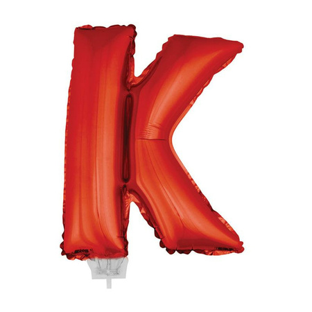 Red inflatable letter balloon K on a stick